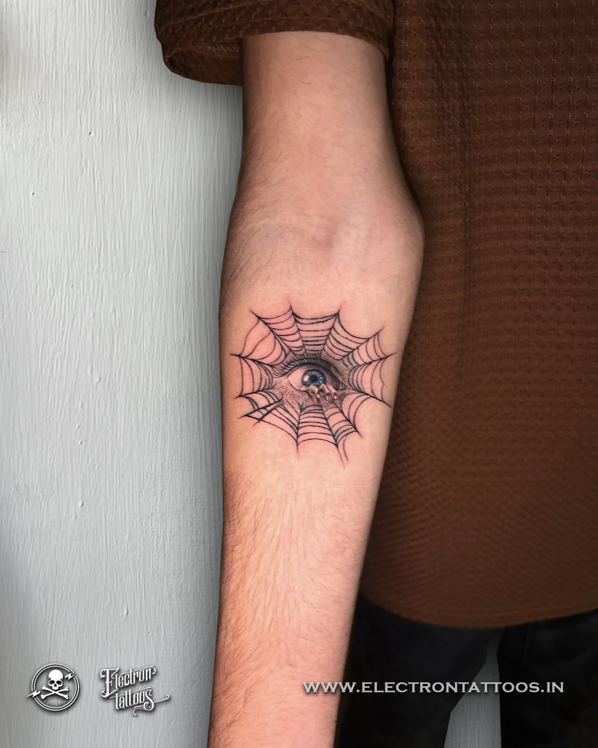 Spider web and eye custom tattoo by Electron Tattoos Gandhidham